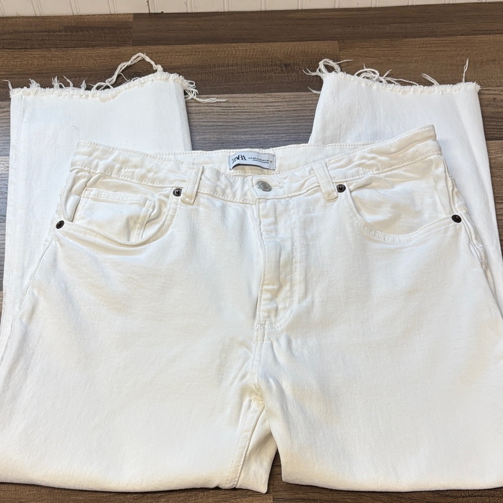 Zara jeans feature a straight-leg cut with a distressed, raw frayed hem